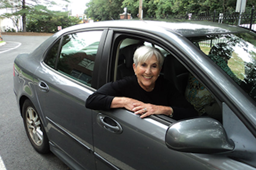 Woman smiling in car.